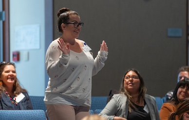 Audience member asks question at forum addressing gender-based violence prevention.